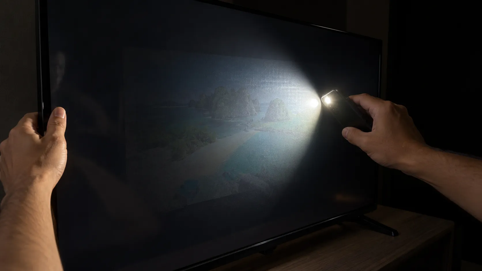 Flashlight test on dim flickering Insignia TV showing backlight failure.