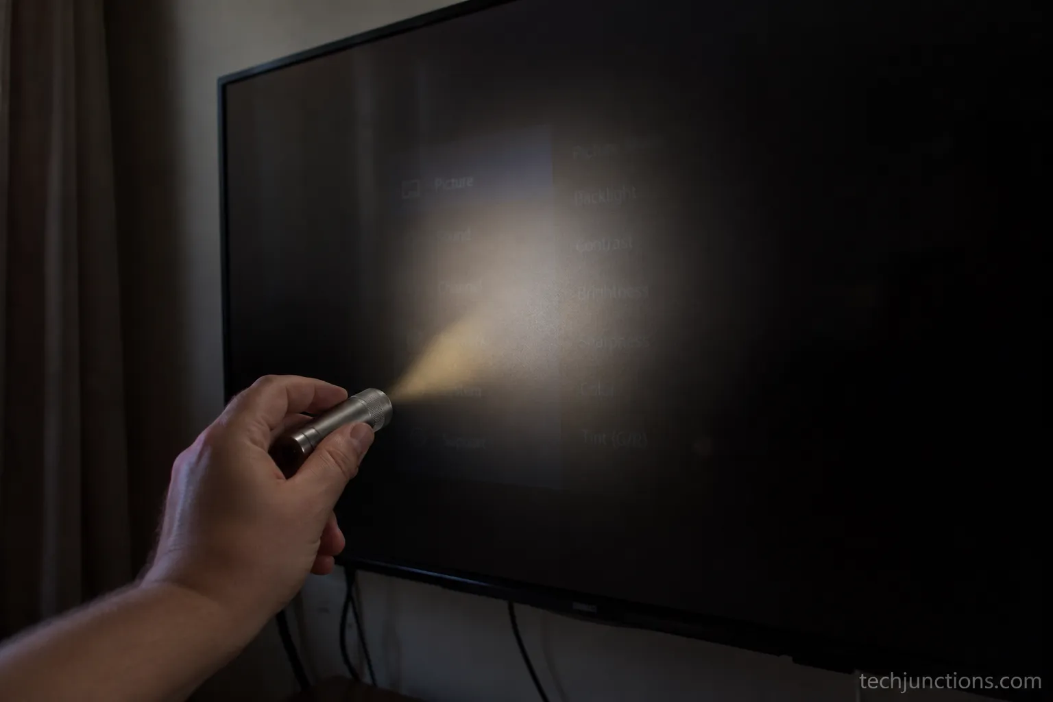 Flashlight test on a Samsung TV showing a faint image confirming backlight failure