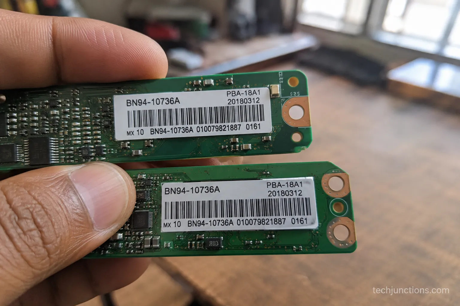 TV main board part-number sticker beside a matching replacement board.
