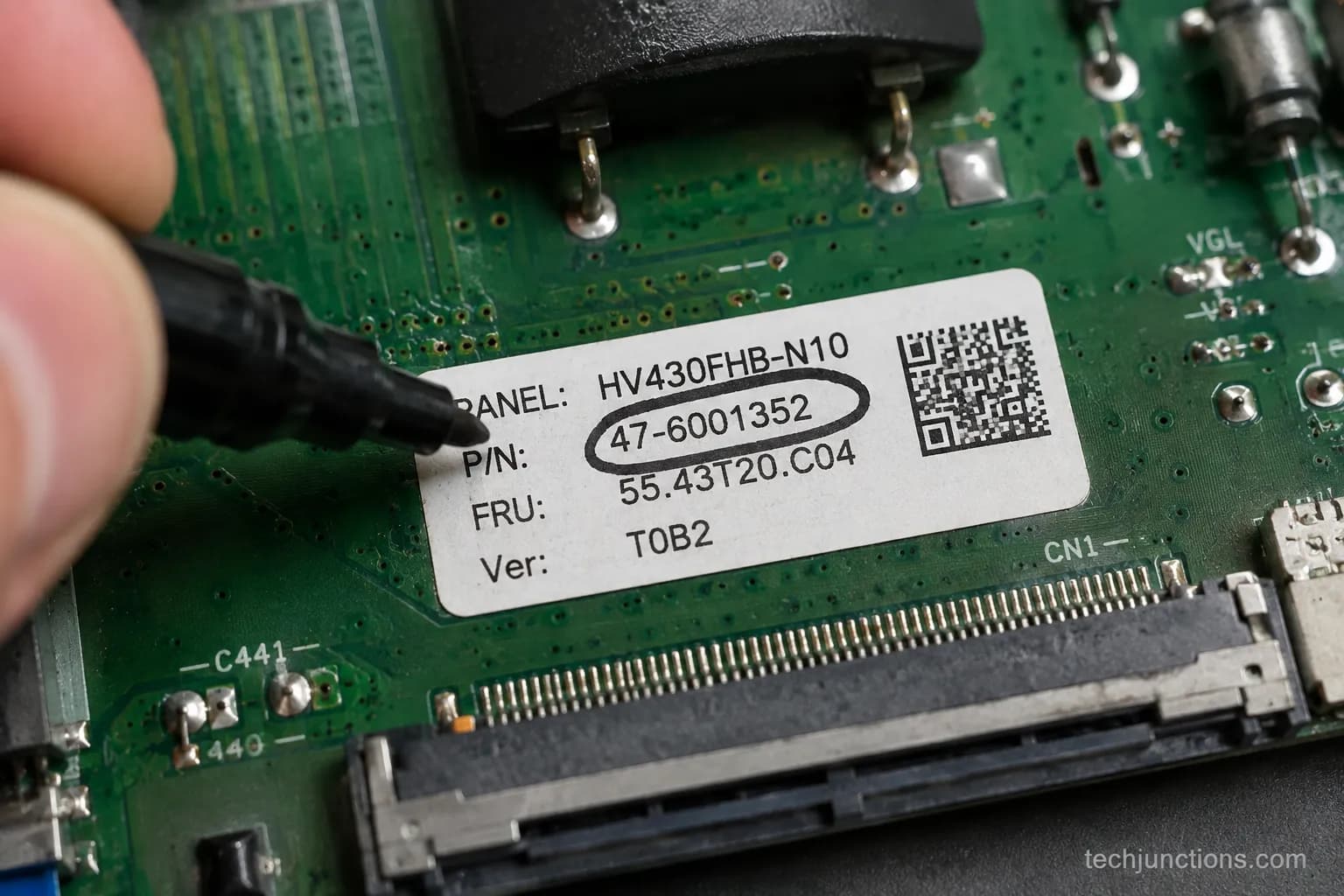 A TV board part-number sticker circled by hand for ordering the correct part