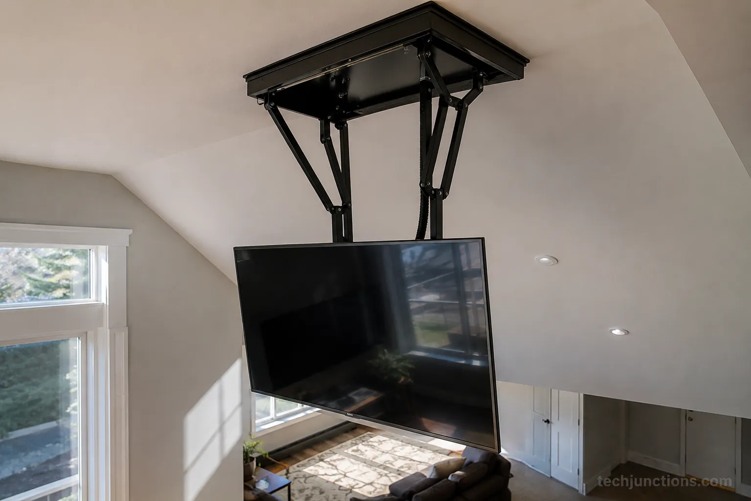Ceiling pull down TV mount lowering a TV from an overhead sloped position