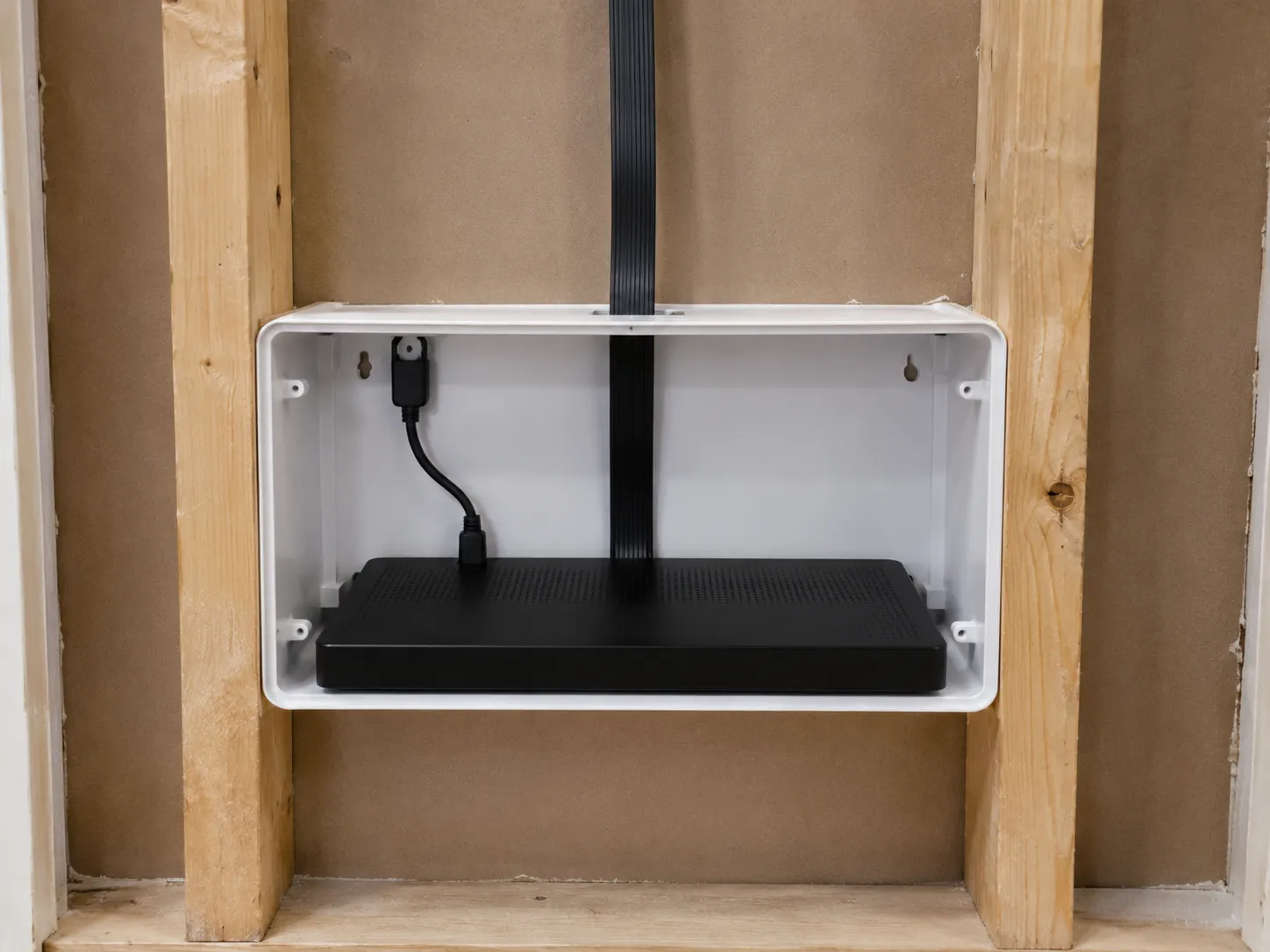 Samsung One Connect box inside a recessed in-wall media enclosure between studs behind The Frame