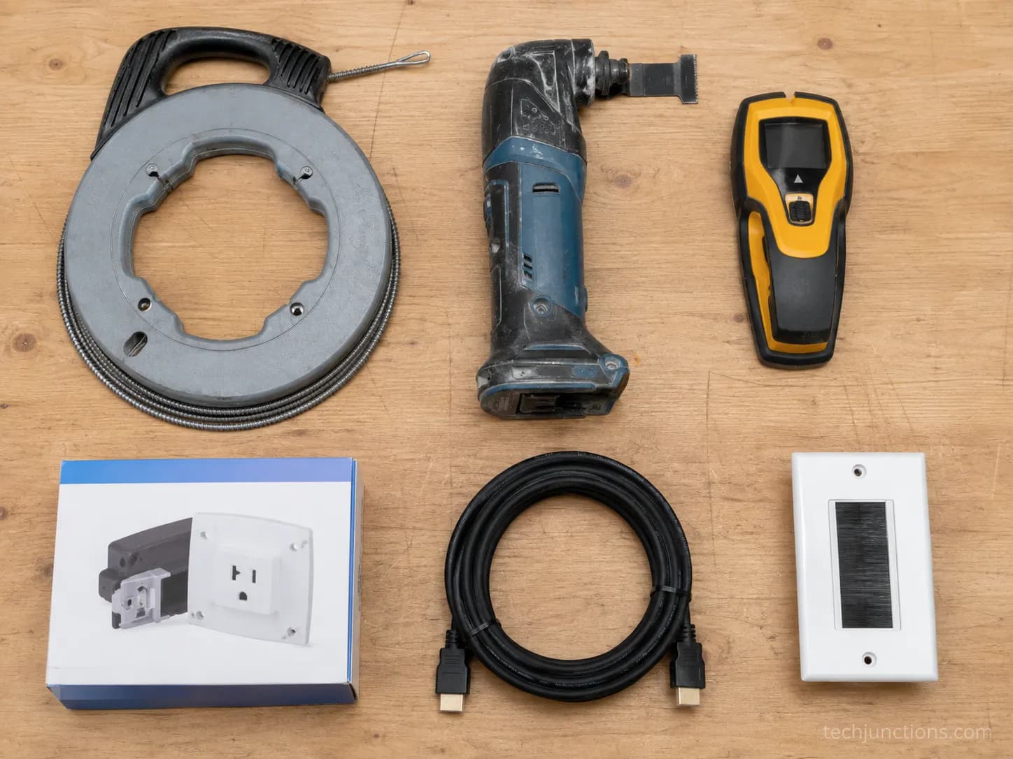 Flat-lay of fish tape, oscillating tool, stud finder, power-relocation kit and CL3 HDMI for hiding Samsung TV cables
