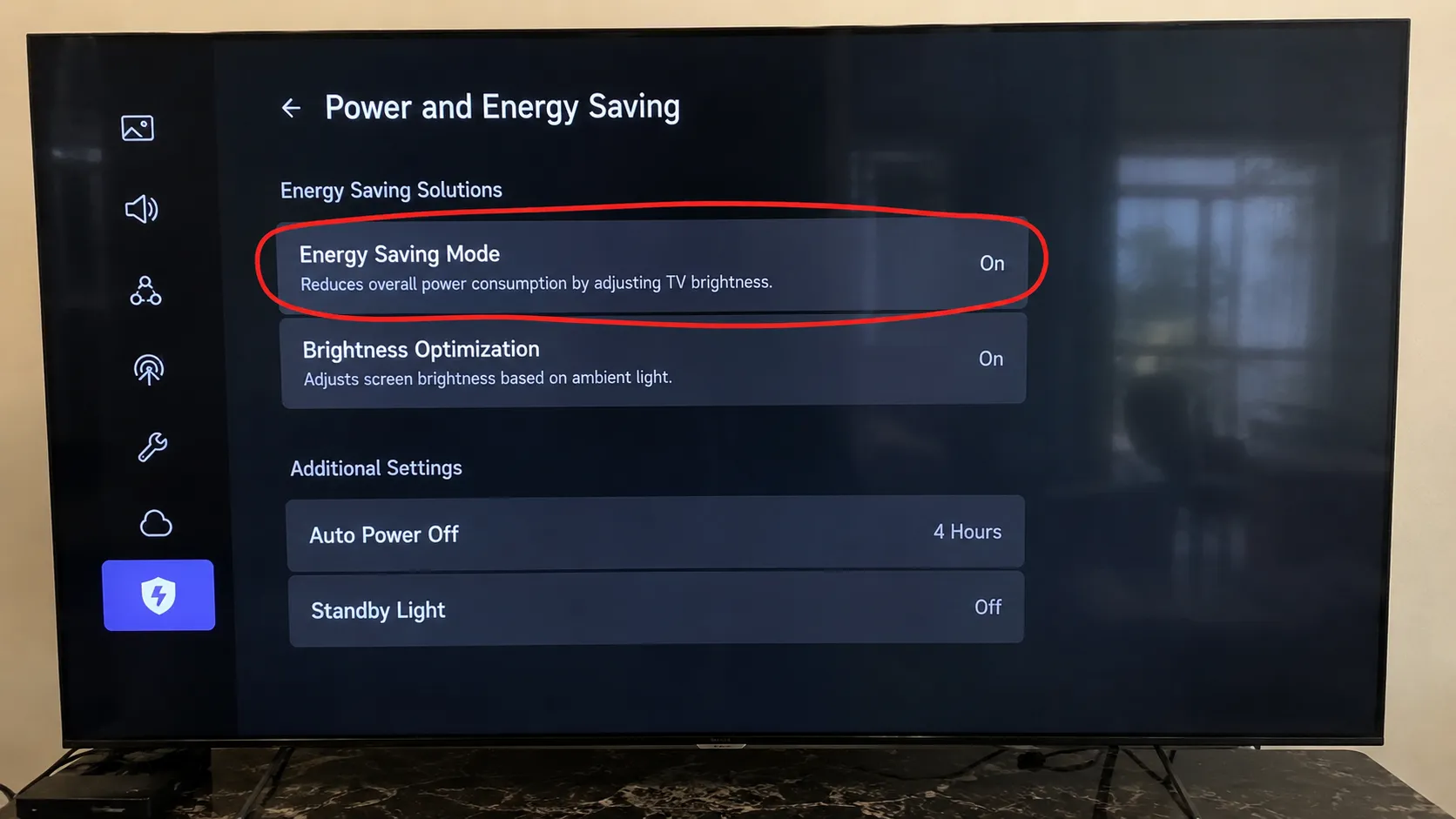 TV Power and Energy Saving settings menu with the Energy Saving Mode option circled, showing the brightness-reduction setting that can make a television screen appear dim.