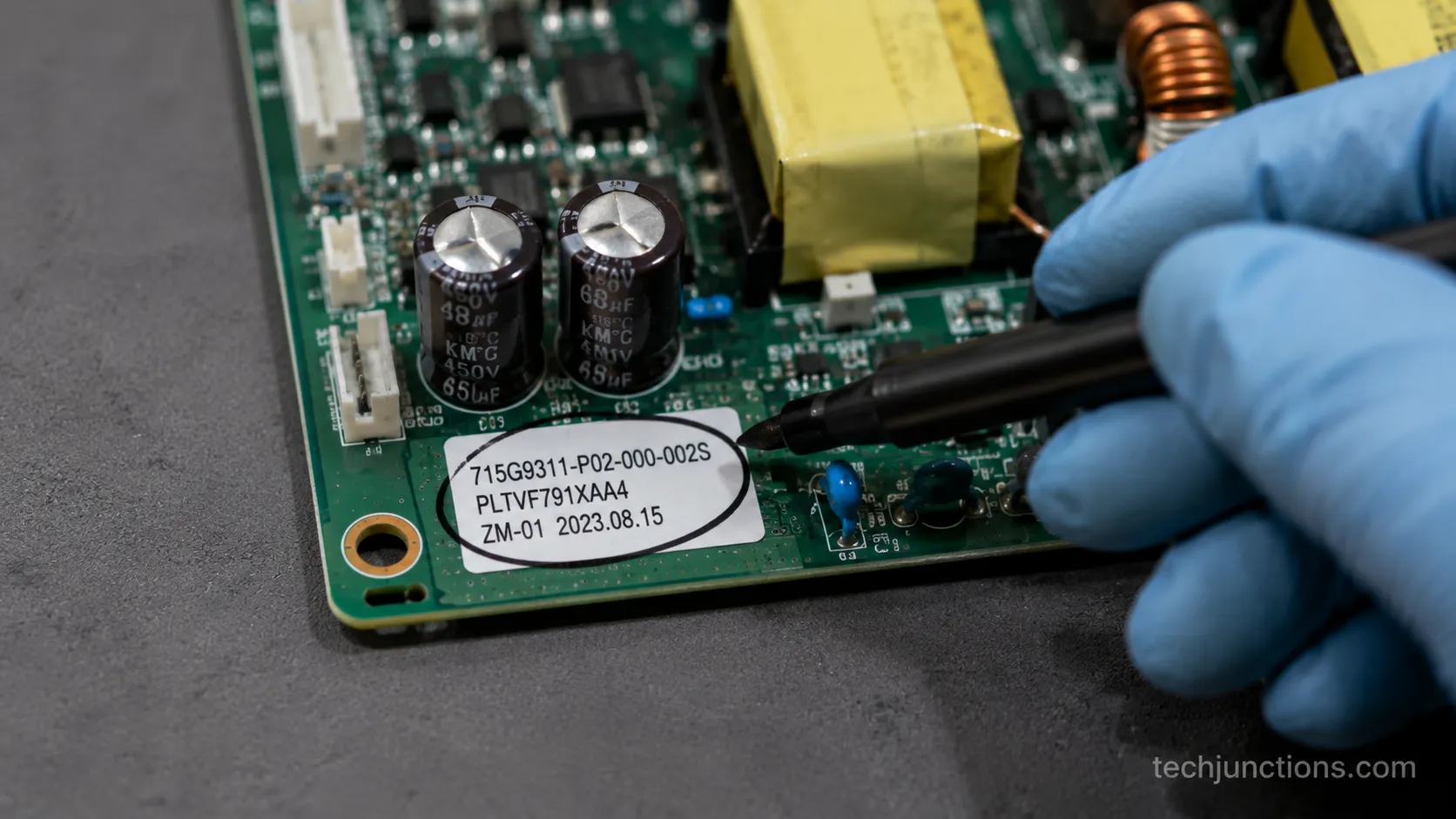 Close-up of a TV power board part number sticker being circled