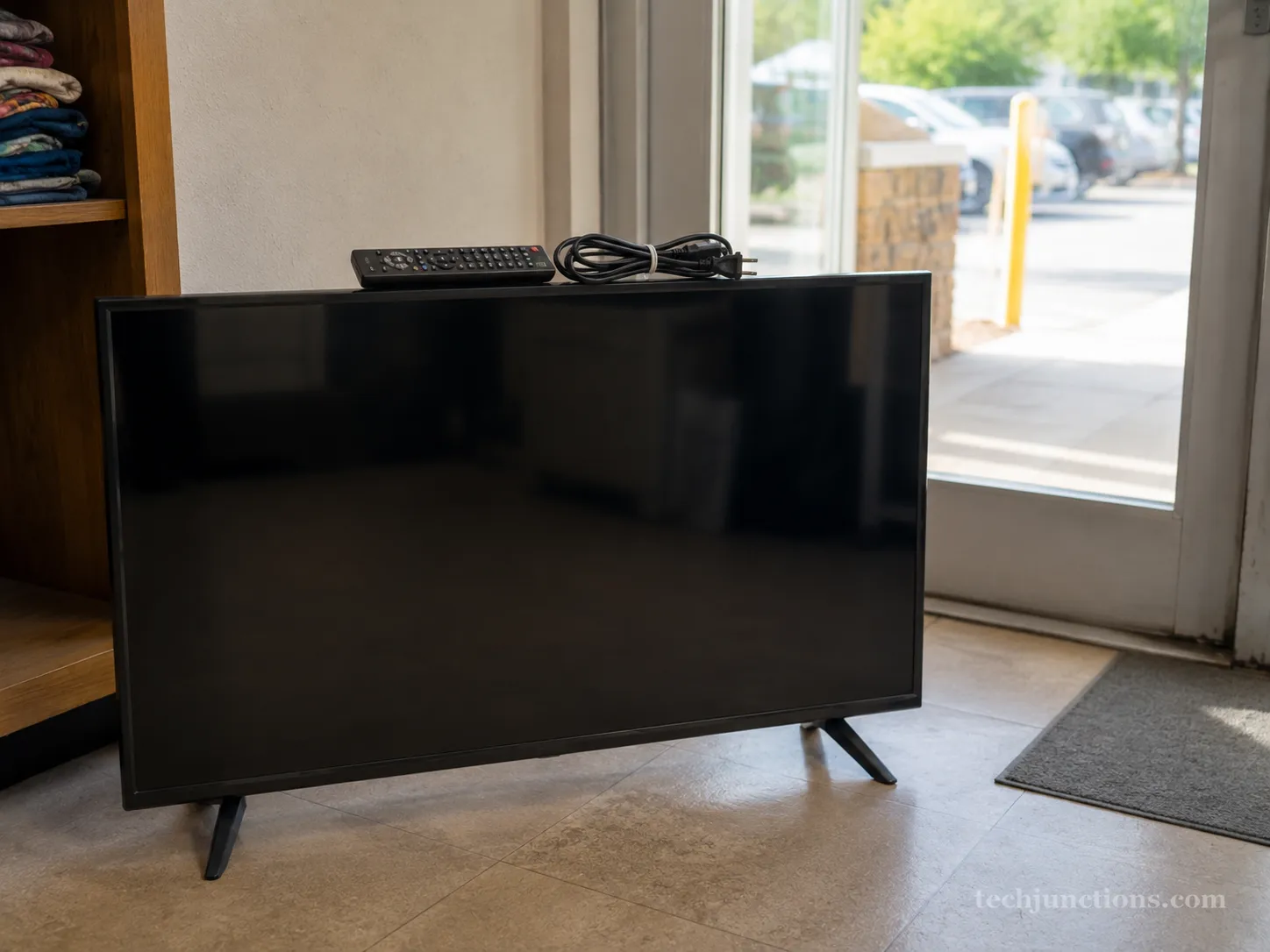 A working flat-screen TV with remote and cable, prepared for charity donation